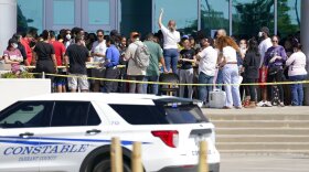 Families are addressed by an unidentified person at center, as they wait to be reunited with their children at the Mansfield ISD Center For The Performing Arts, Wednesday, Oct. 6, 2021, in Mansfield, Texas, following a school shooting at Timberview High School in Arlington.