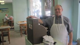 Pete Michailakis at the register of Gregory & Pete's in the CBD.
