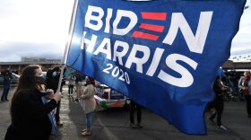 Melissa Vandervort of Nevada carries a Biden-Harris flag as supporters of Joe Biden prepare to hold a car parade to celebrate the outcome of Tuesday's election in Las Vegas, Nevada. 