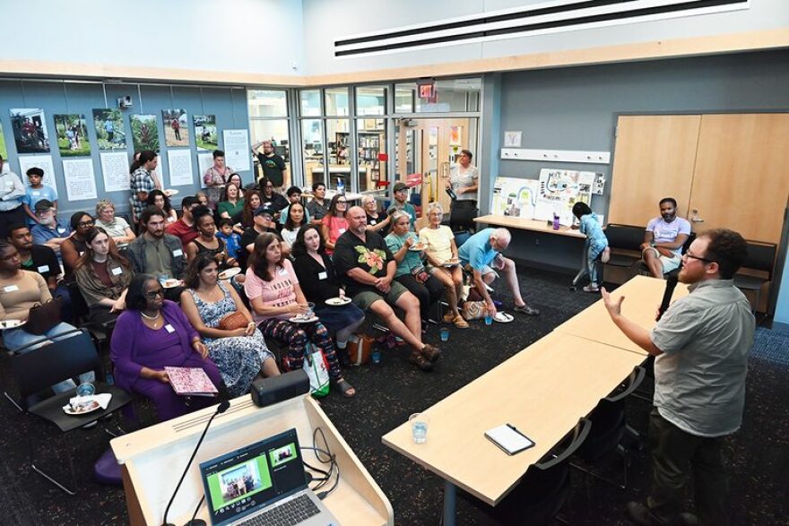 Finn Bell speaks at an opening reception for the expansion of the Ypsi Farmers & Gardeners Oral History Project.