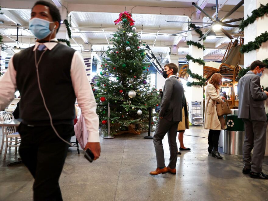 People wear face coverings inside Grand Central Market on December 15, 2021 in Los Angeles, California. California residents, regardless of COVID-19 vaccination status, are required to wear face masks in all indoor public settings beginning today.