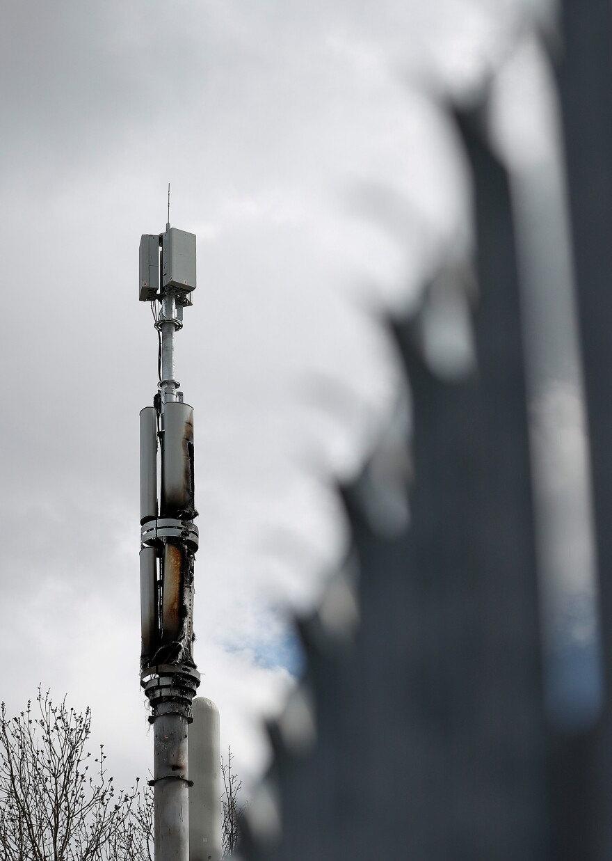 A fire-damaged telecom tower stands in Birmingham, England, in April. Authorities have cited conspiracy theories about 5G and the coronavirus as a possible motivation for a rash of such fires in the U.K.
