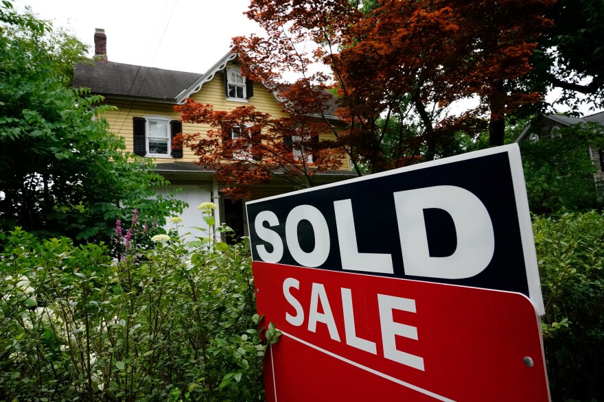 A sold sign stands outside a home in Wyndmoor, Pa., on June 22, 2022. Two recent studies suggest that prospective homeowners will have to earn more than $100,000 annually to afford a typical home in much of the U.S.