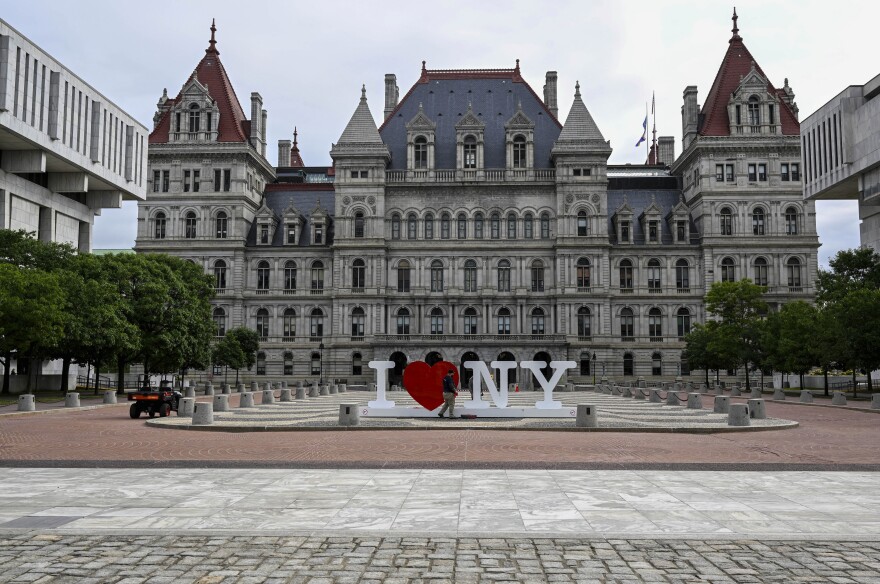 FILE - The New York state Capitol is seen as Assembly members return after the regular legislative session ended to work on unfinished business in Albany, N.Y., Tuesday, June 20, 2023. Hospitals and other health care providers in New York would be banned from reporting medical debt to credit reporting agencies under a bill passed this week by the state's legislature. (AP Photo/Hans Pennink, File)