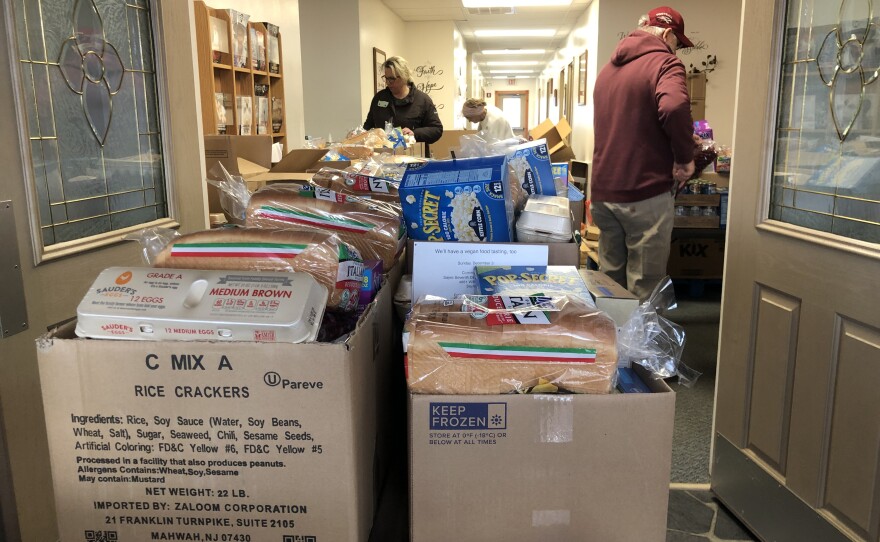 CHOP coordinator, Nicole Heyer works with volunteers to pack boxes with donated food items for a Pop Up Pantry in Sayre, Pa.