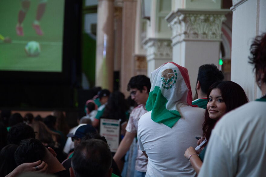 Fan with Mexican flag over his head