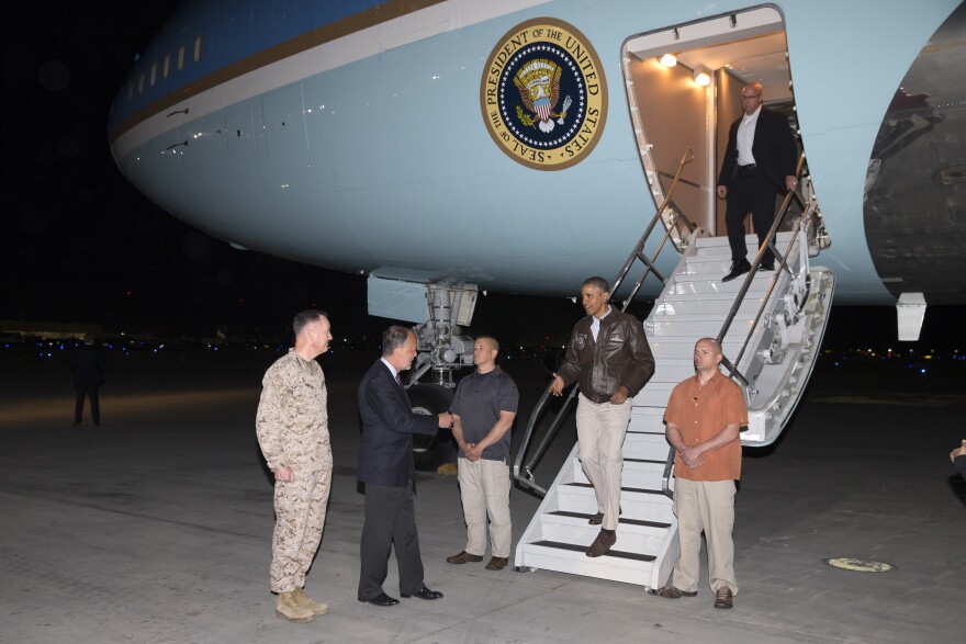 President Barack Obama is greeted by U.S. Ambassador to Afghanistan James Cunningham and Marine General Joseph Dunford, commander of the U.S.-led International Security Assistance Force (ISAF), as he steps off Air Force One at Bagram Air Field in Afghanistan.