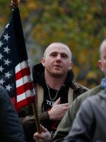 Attendees recite the Pledge of Allegiance during the United Against Hate rally by the Washington Three Percent in Seattle last month.