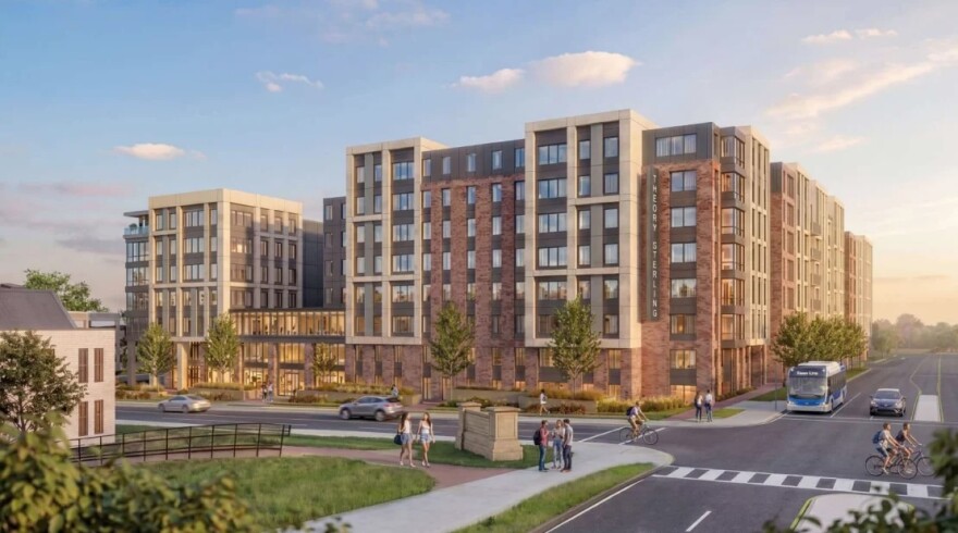 Rendering of a modern apartment complex on the corner of a busy road with cars, bicyclers, and pedestrians.