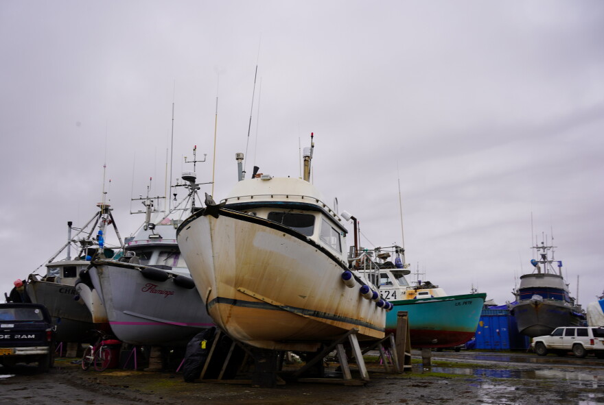  Line of drift boats in a boatyard on a rainy day