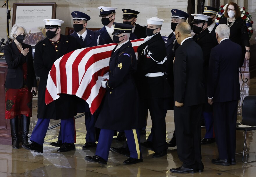 A U.S. Joint Forces bearer team carries the casket of former Senate Majority Leader Harry Reid into the Rotunda of the Capitol.