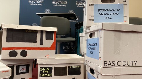 Boxes of Stronger Muni for All petitions, some painted to look like Muni Buses. 