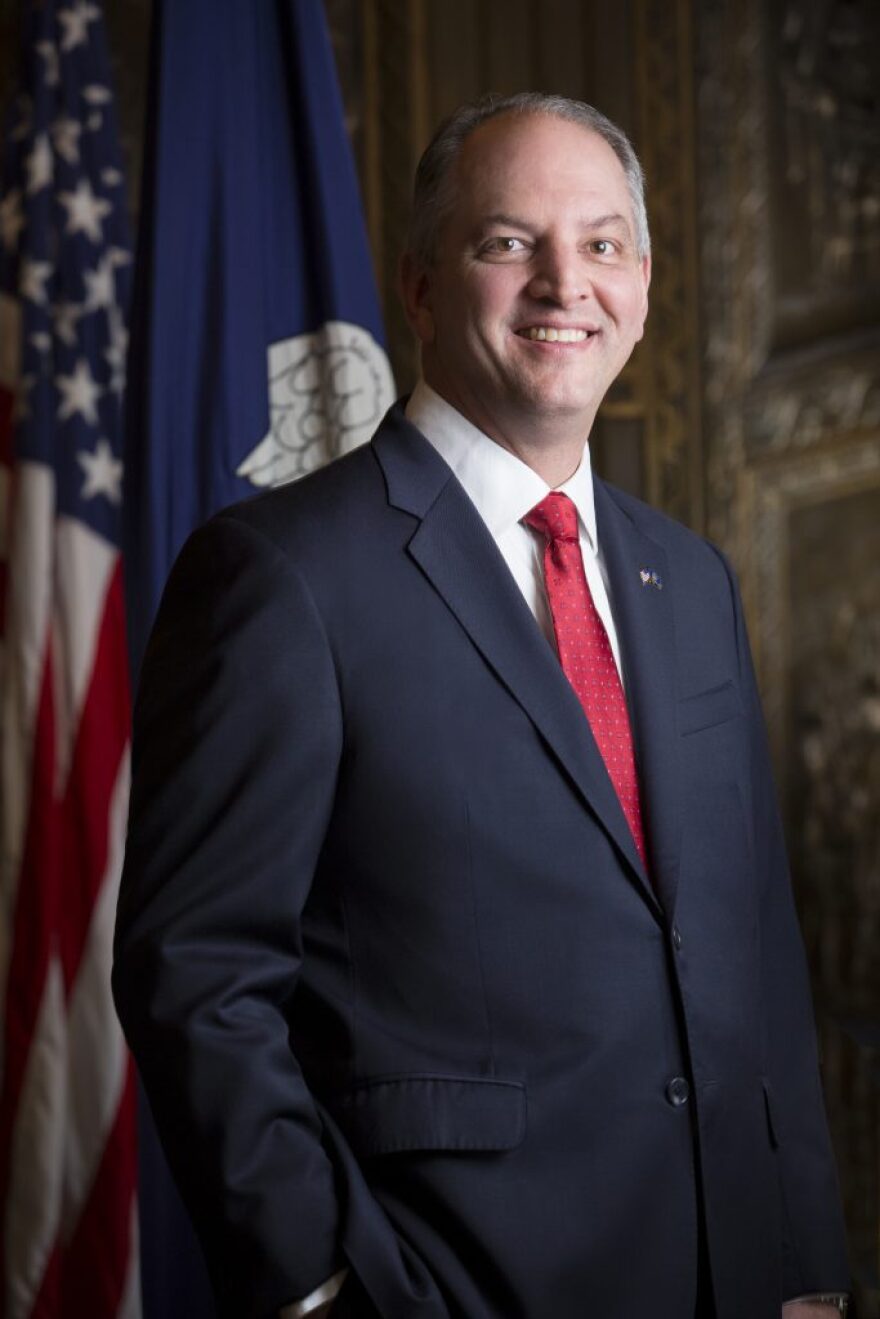 Man in a suit with the American flag in the background