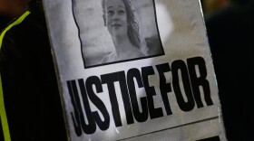 Anna Donigan protests during a rally for Renee Good, who was fatally shot by an ICE officer in Minneapolis the day before, Thursday, Jan. 8, 2026, in Kansas City, Mo. (AP Photo/Charlie Riedel)