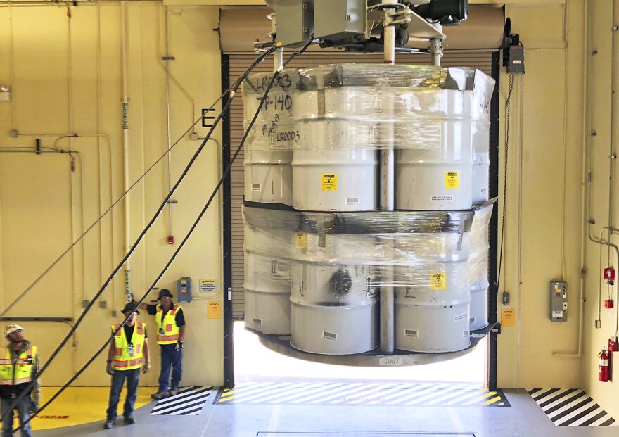 FILE - In this April 9, 2019, file photo, provided by Los Alamos National Laboratory, barrels of radioactive waste are loaded for transport to the Waste Isolation Pilot Plant, marking the first transuranic waste loading operations in five years at the Radioactive Assay Nondestructive Testing (RANT) facility in Los Alamos, N.M. On Thursday, Dec. 8, 2022, New Mexico officials outlined new conditions for a proposed permit for the U.S. government to continue disposing of nuclear waste in the southeast corner of the state as part of a multibillion-dollar federal cleanup program. (Nestor Trujillo/Los Alamos National Laboratory via AP, File)