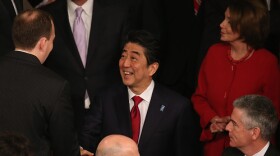 Prime Minister Shinzo Abe is greeted by members before speaking to a joint meeting of Congress, the first Japanese prime minister to do so.