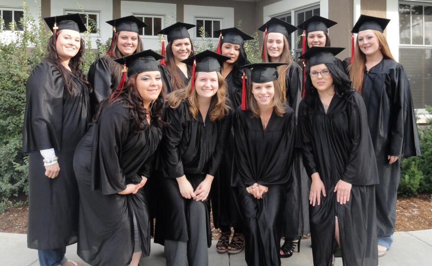 A group of women in black graduation caps and gowns