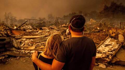 Megan Mantia, left, and her boyfriend Thomas, return to Mantia's fire-damaged home after the Eaton Fire swept through, Jan. 8, 2025 in Altadena, Calif. (Ethan Swope/AP)