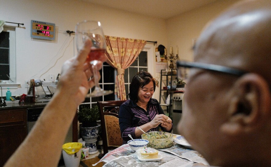 After work, the couple make dumplings together. Here, Lai fills a dumpling with pork and shapes the remaining rounds, as Chan drinks wine and makes jokes.