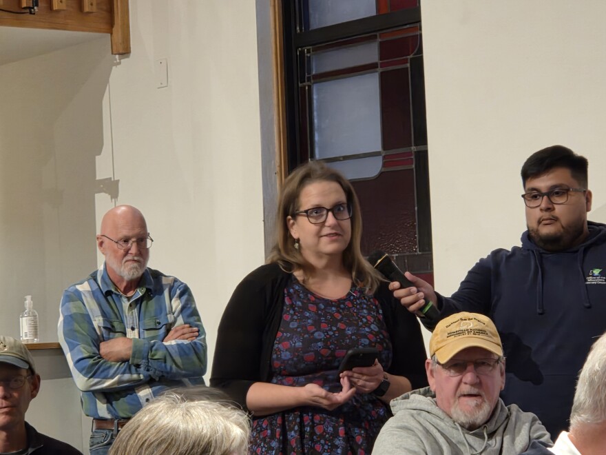 Emily Thabes, executive director of the Beltrami County Historical Society, asks Attorney General Keith Ellison about the office's planned actions to restore funding for the Institute of Museum and Library Services during a community forum at Bemidji's United Methodist Church on Oct. 7, 2025.