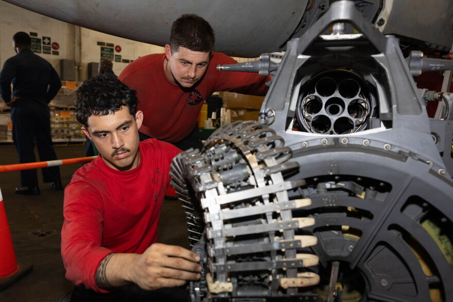 Sailors conduct maintenance on an F/A-18E Super Hornet machine gun aboard Nimitz-class aircraft carrier USS George H.W. Bush.