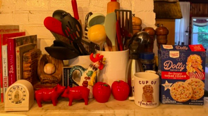 The writer's kitchen counter, featuring “a cup of ambition” and Parton-brand sugar cookie mix.