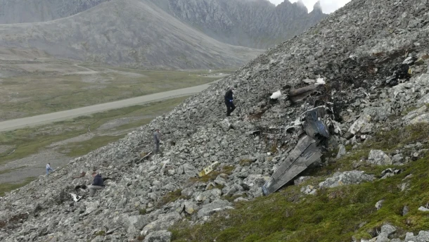 Investigators with the National Transportation Safety Board are seen on Aug. 23, 2026 documenting wreckage of a Cessna 441 that crashed on Cape Newenham in Southwest Alaska three days earlier, killing all eight people on board.