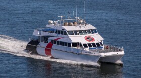 The white and red Cross-Bay Ferry on the water.