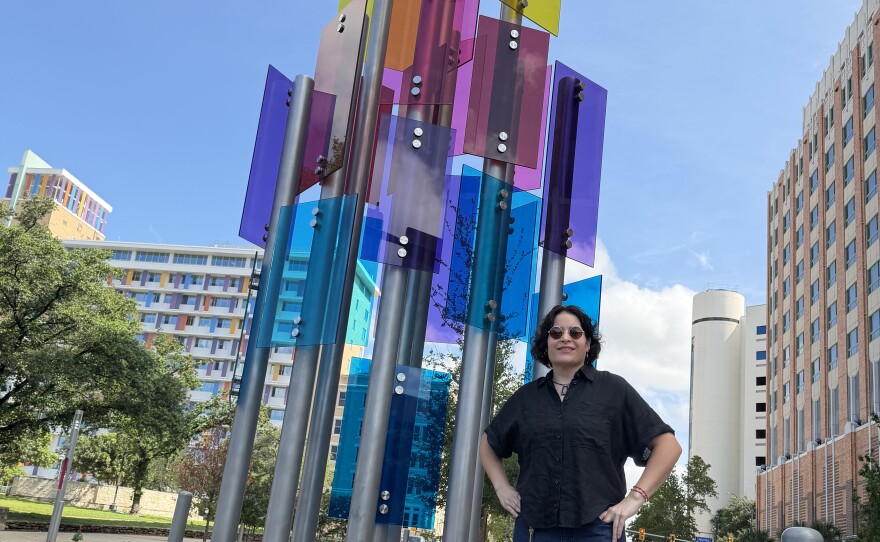 Rhys in front of her sculpture
