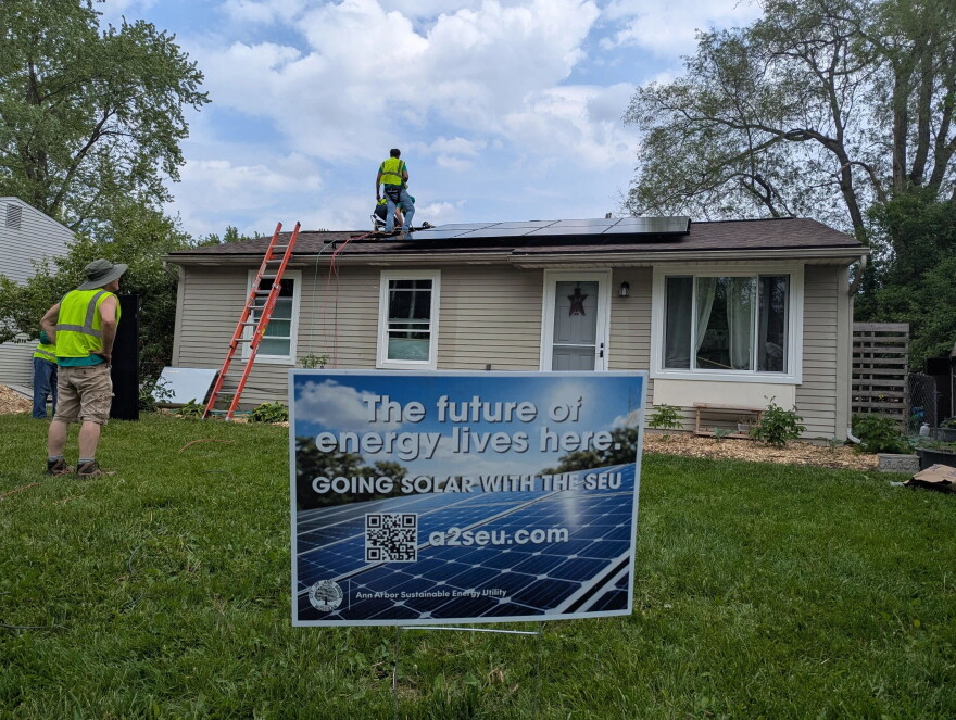 A house in Ann Arbor's Bryant neighborhood gets fitted with solar panels.