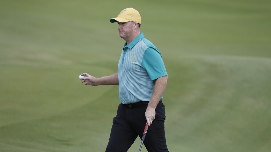 Marcus Fraser of Australia chips to the 16th hole during the first round of golf at the Olympics. Fraser shot a 63 to take a three-stroke lead. Thursday's play marked the return of golf to the games after a 112-year absence.