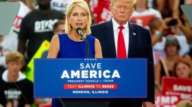 Rep. Mary Miller speaks as former President Donald Trump stands nearby on Saturday, June 25, 2022, during a “Save America!” Rally at the Adams County Fairgrounds in Mendon, Ill.