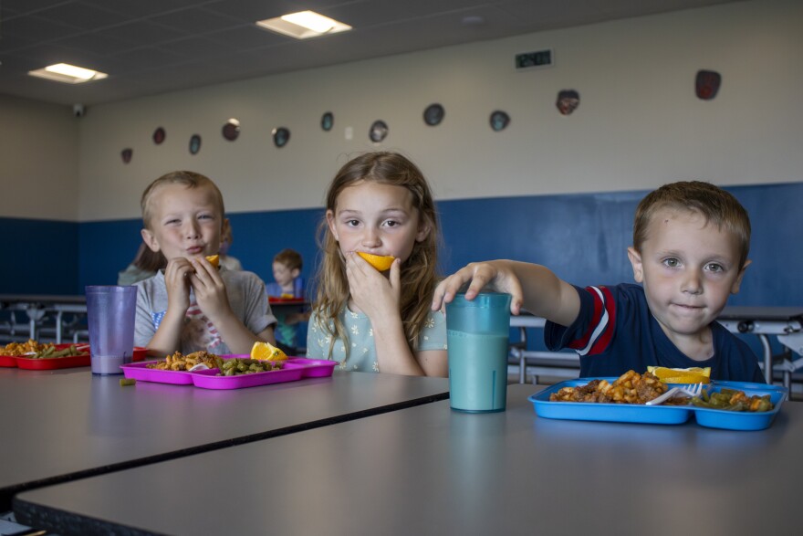 Kids at the Boys and Girls Club of Alpena eat pasta, oranges and green beans for lunch during the club’s first day of summer on Monday