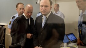 In this picture taken through bullet proof glass, mass killer Anders Behring Breivik looks on as he arrives for his trial in room 250 of Oslo's central court on June 21, 2012.
