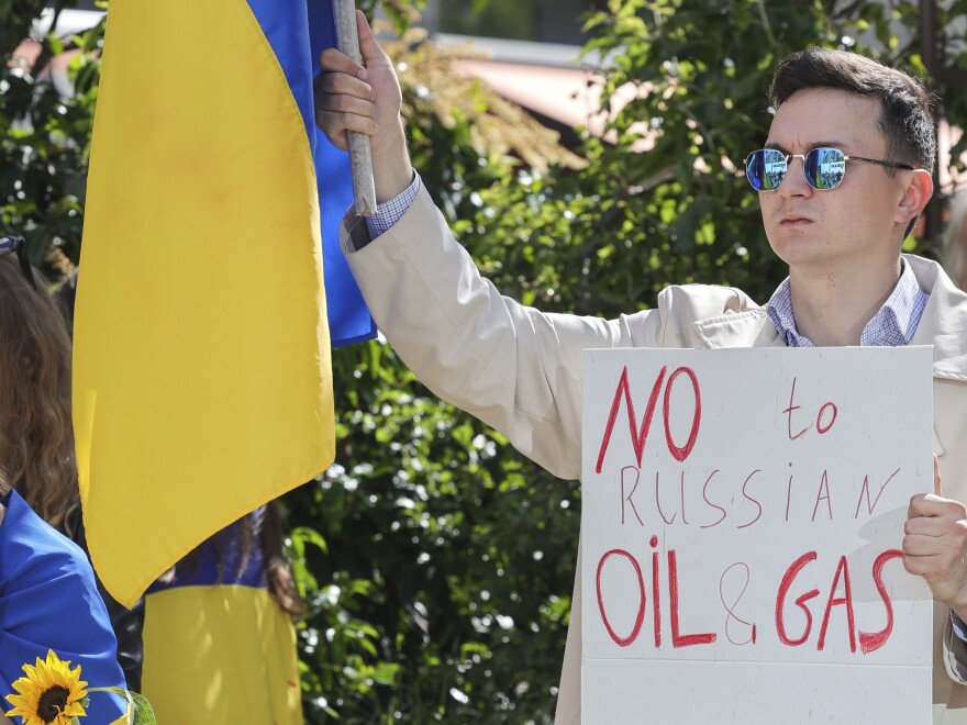 Demonstrators demand an embargo on Russian oil during a protest in front of EU institutions prior to an extraordinary meeting of EU leaders to discuss Ukraine, energy and food security at the Europa building in Brussels on Monday.