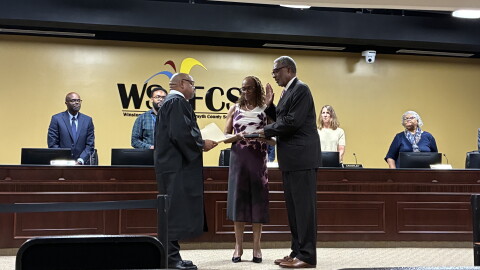 Randy Bridges takes the oath of office in front of school board members