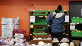 A resident picks up fresh produce at the Berkley food hub.