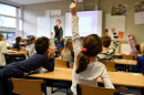 girl raises hand in classroom