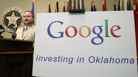 Mike Wooten, data center operations manager for Google in Pryor, Okla, stands next to a large Google sign as he announces plans for Google to double its server capacity in Oklahoma and add 50 new jobs when it builds a new facility in the state, during a news conference in Oklahoma City, Wednesday, April 4, 2012. 