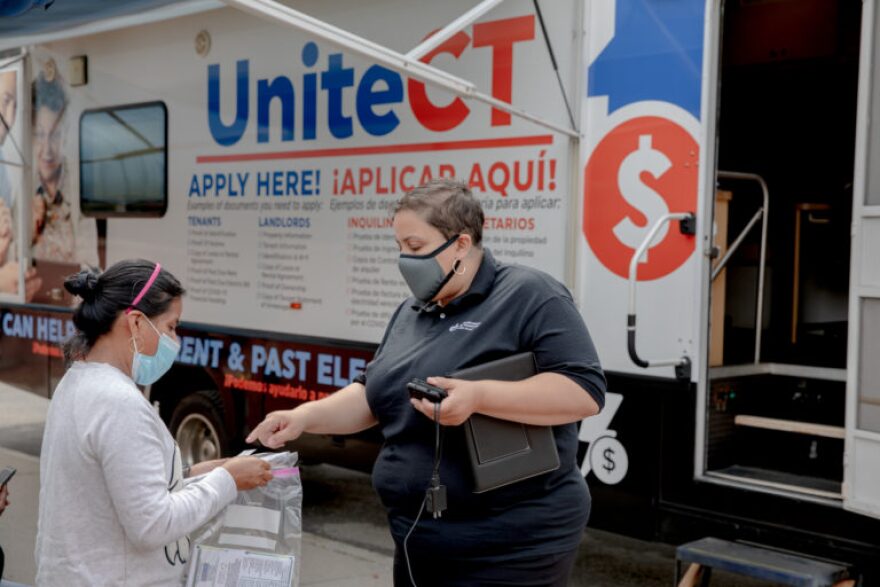 Denise Martinez, right, community outreach coordinator at New Opportunities, explains the UniteCT program to a landlord who didn't want to be named. The rental assistance program requires an application from both tenants and landlords.