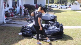 Dawn Gilliam with her belongings. Gilliam has been experiencing mold issues and health problems since she moved into Holly Plaza. Now, she's sorting through what she can take with her and what's too moldy to salvage.