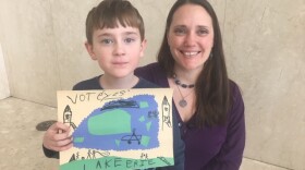 Stefania Czech, Toledoan for Safe Water member, and her 6-year-old son, Mirek, participate in a press conference denouncing outside money funding negative ads against the charter amendment