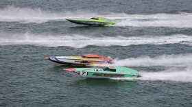 Two boats race each other on the water 