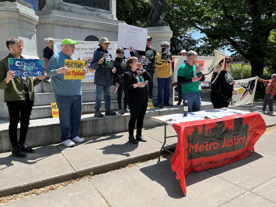  Supporters of the Climate, Jobs & Justice Package rally in the center of Washington Square Park in Rochester.