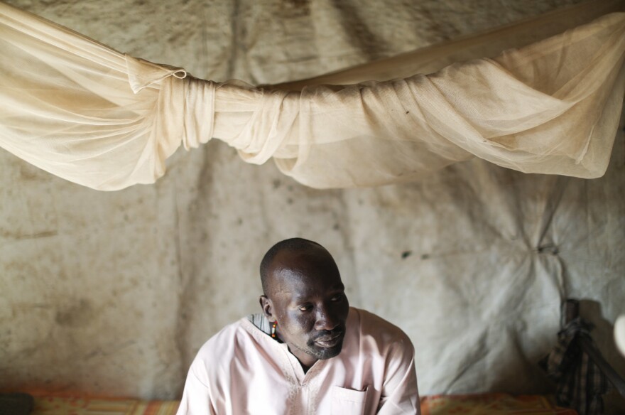David, a South Sudanese health worker at the MSF facility, sits on his bed in his shelter. He's one of the 124,000 people who've come to the camp to escape the fighting. We were asked by MSF only to use the first names of local employees for security reasons.