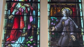 A stained glass window in St Joseph's Church in West Warwick depicting Christ revealing his Sacred Heart to St. Margaret Mary Alacoque, a 17th Century French nun who reported experiencing divine visions which sparked a devotional movement that spread worldwide, especially among French-Canadian Catholics.