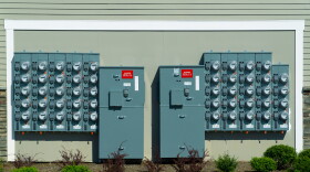 Power meters on multi-unit residential building wall