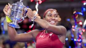 Coco Gauff, of the United States, holds up the championship trophy after defeating Aryna Sabalenka, of Belarus, in the women's singles final of the U.S. Open tennis championships. (Frank Franklin II/AP)