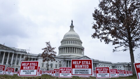 Signs reading "Help Still Wanted" are positioned on the lawn outside the U.S. Capitol on Jan. 5. The House is set to vote on a coronavirus relief package by the end of the week.