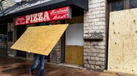 Workers boarded up bars on Sixth Street in Austin after Gov. Greg Abbott closed bars in Texas for the second time in three months because of the COVID-19 pandemic on June 26, 2020.